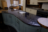 <B>Special shaped island top in Via Lattea Granite with domus edge detail.